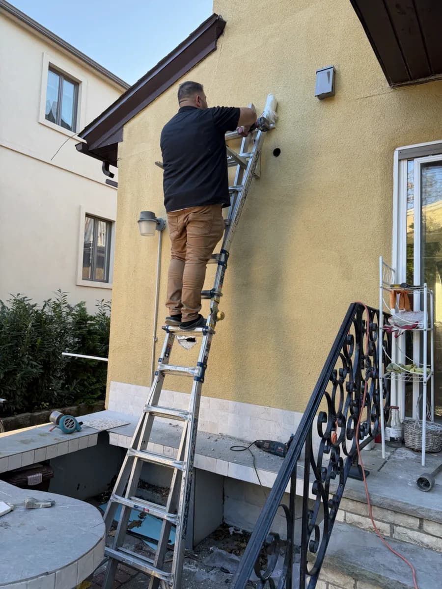 Closer view of a technician working on an exterior wall